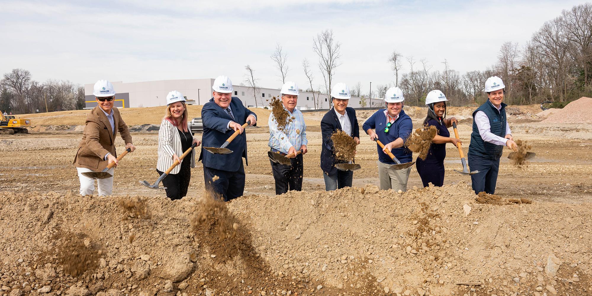 A group of Prince William County leaders throws dirt at a ceremonial groundbreaking. 